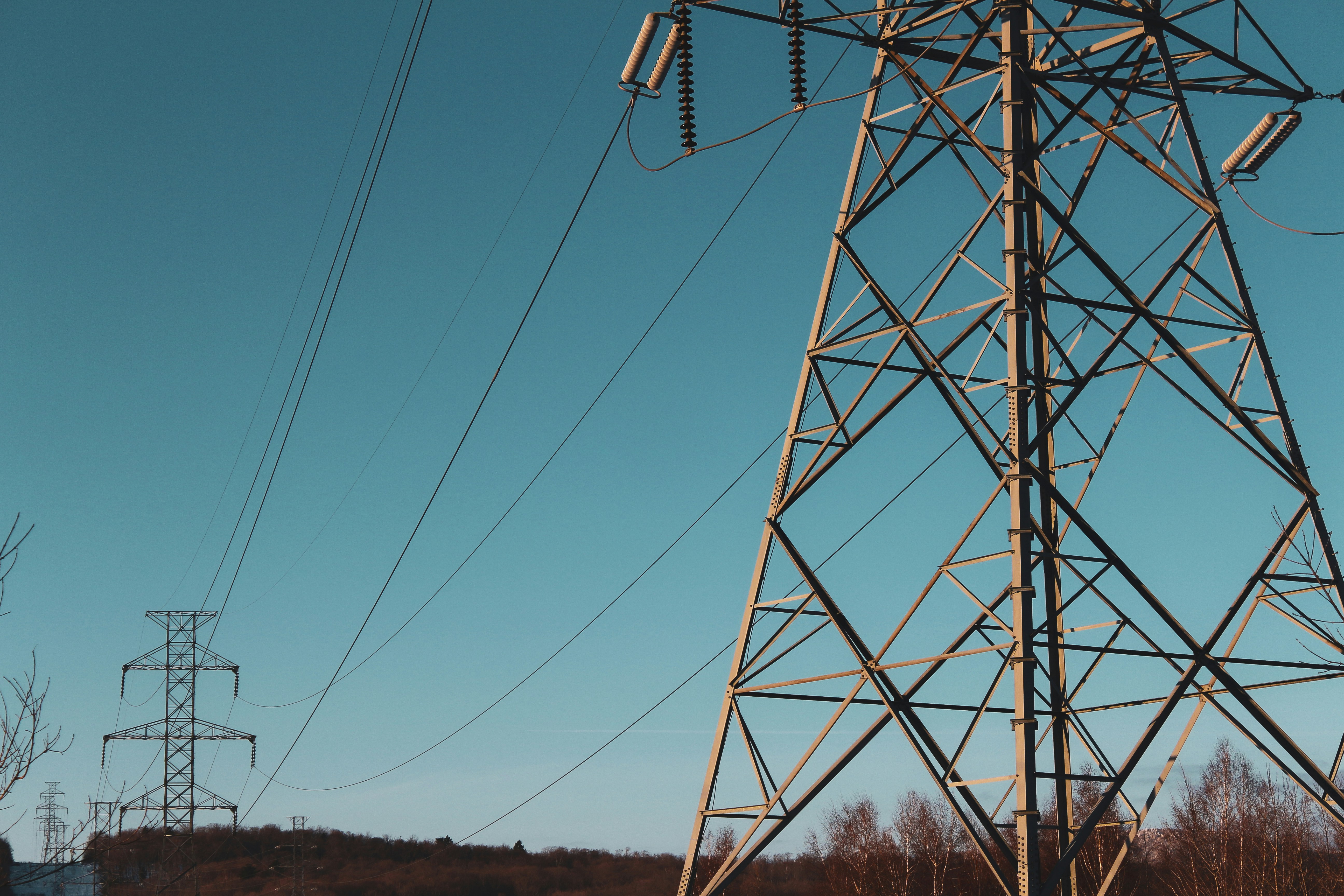 Electrical pylons outdoors at dusk