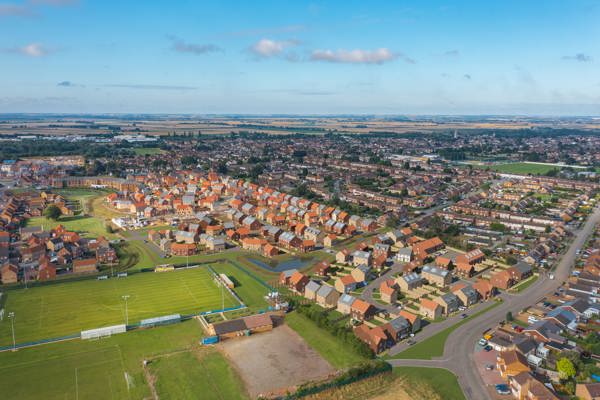 A birds eye view of a thriving town filled with red brick homes