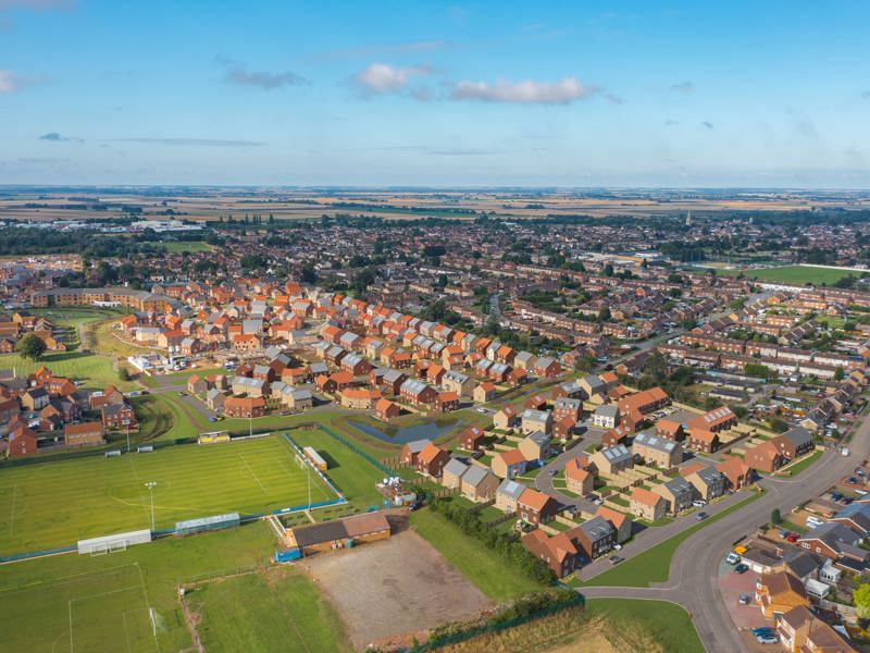 A birds eye view of a thriving town filled with red brick homes