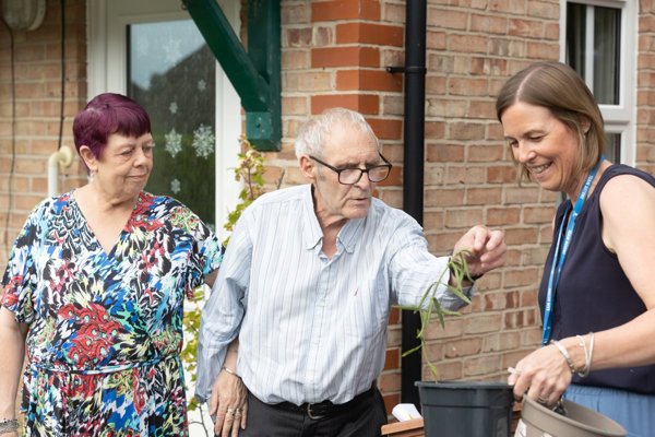 Older Couple In Garden With Housing Partner Alice