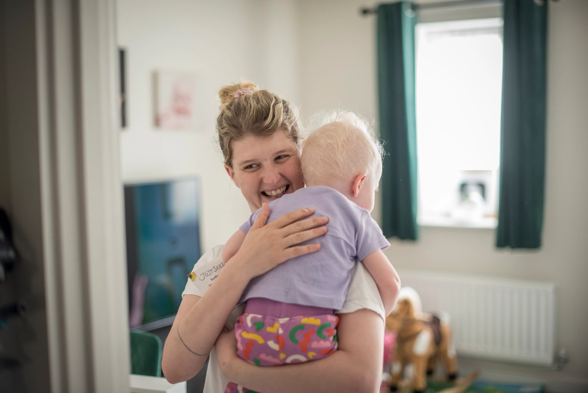 Accent Customer Holding Young Baby