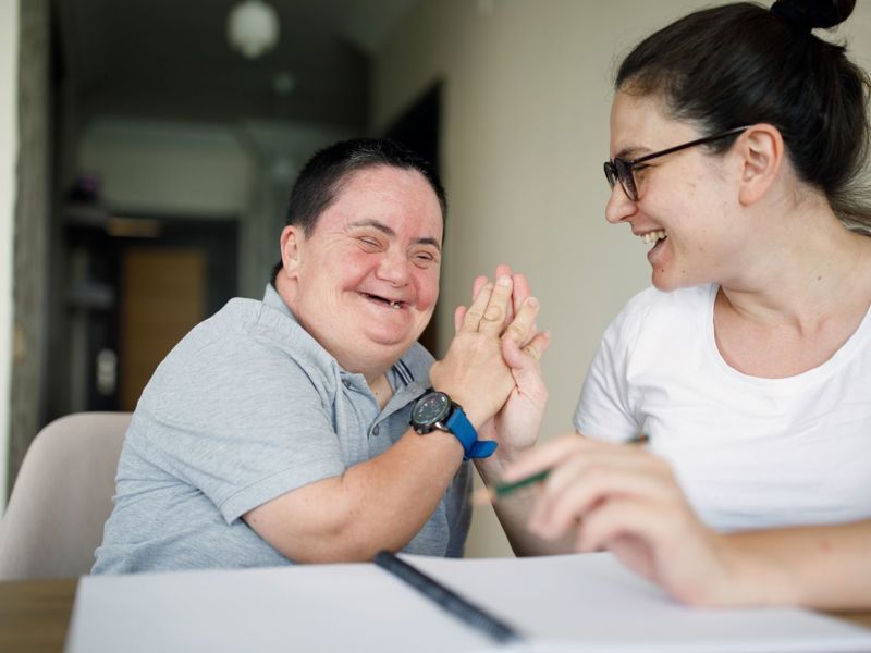 Man With Disability Smiling With Family Member